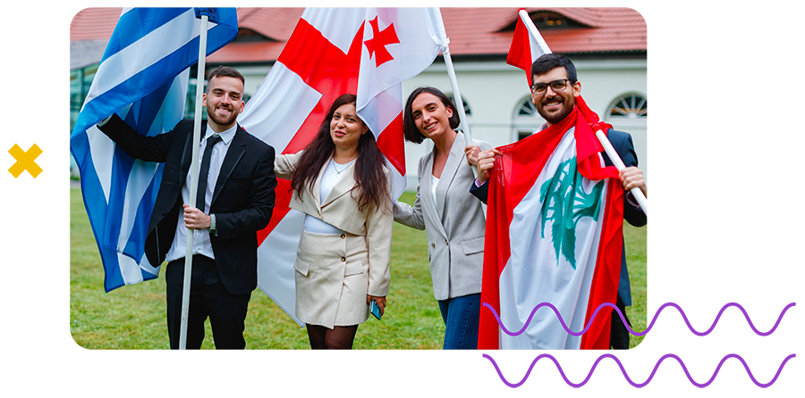 EU4Youth scholarships and fellowships Four smiling young people holding the flags of Greece, Georgia and Lebanon outdoors.