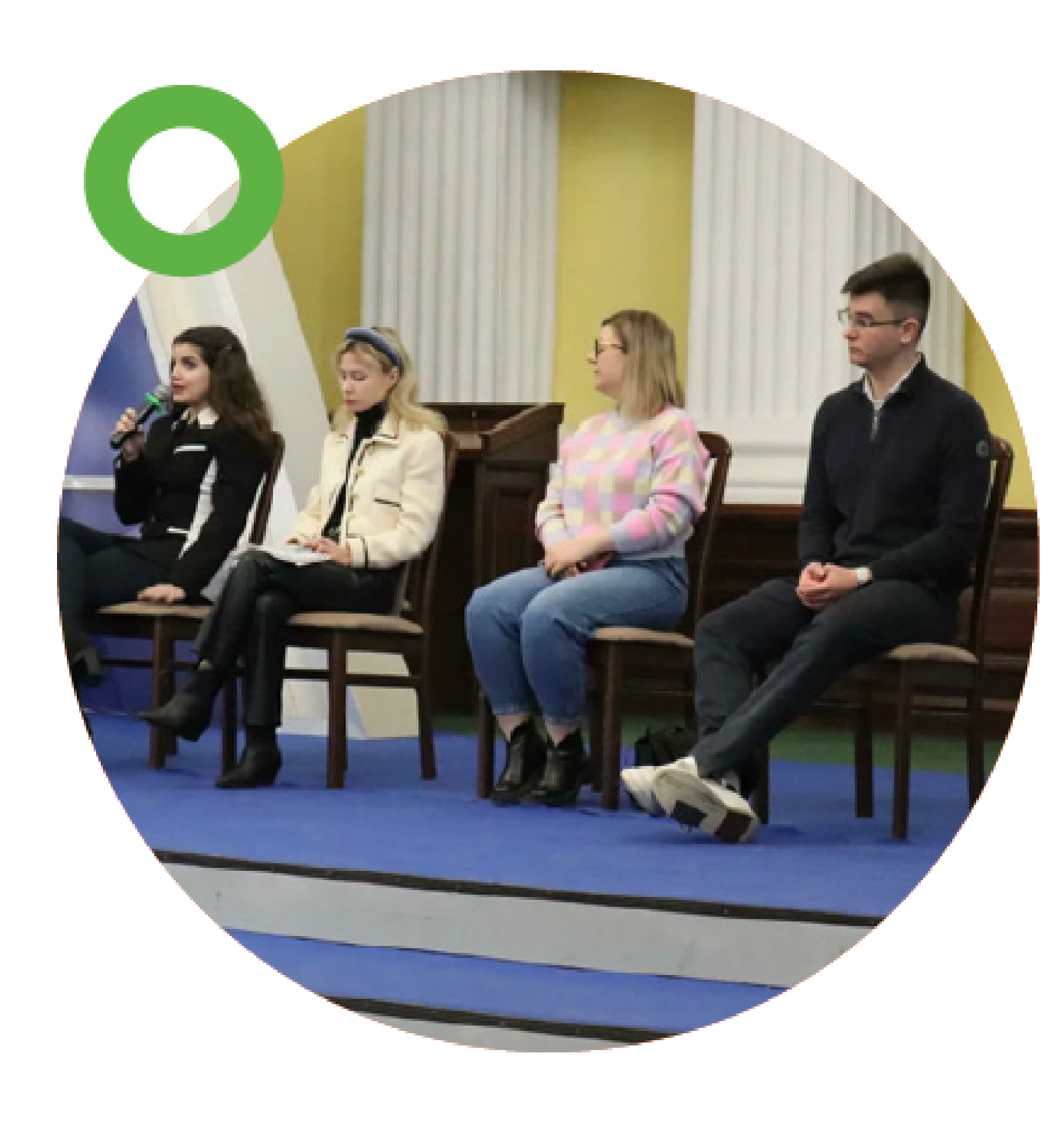 EU4Youth at the Youth Forum by Ukrainian Youth Councils Association Four young people sitting on chairs during a panel discussion, one of them speaking into a microphone.